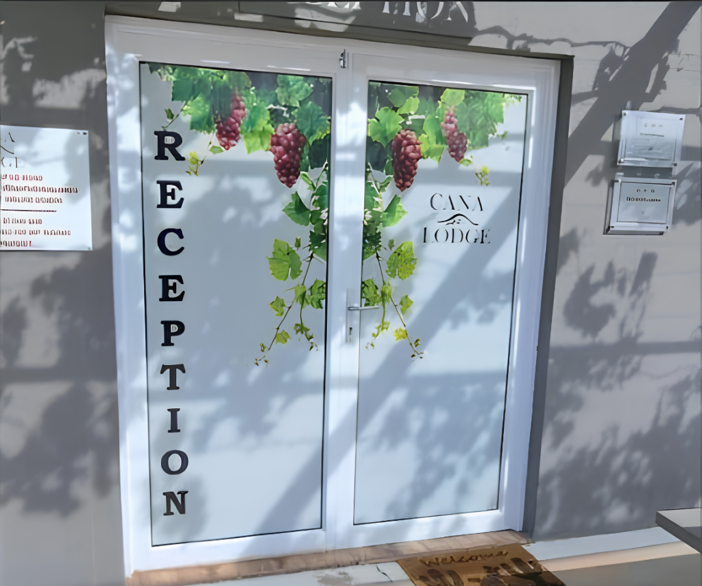 Contra Vision Printing on a window with the logo Cana Lodge on there as well as grape vines on the design