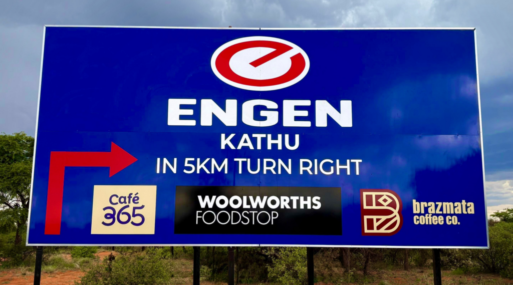 Engen Garage Signage board in field next to the road displaying the company details