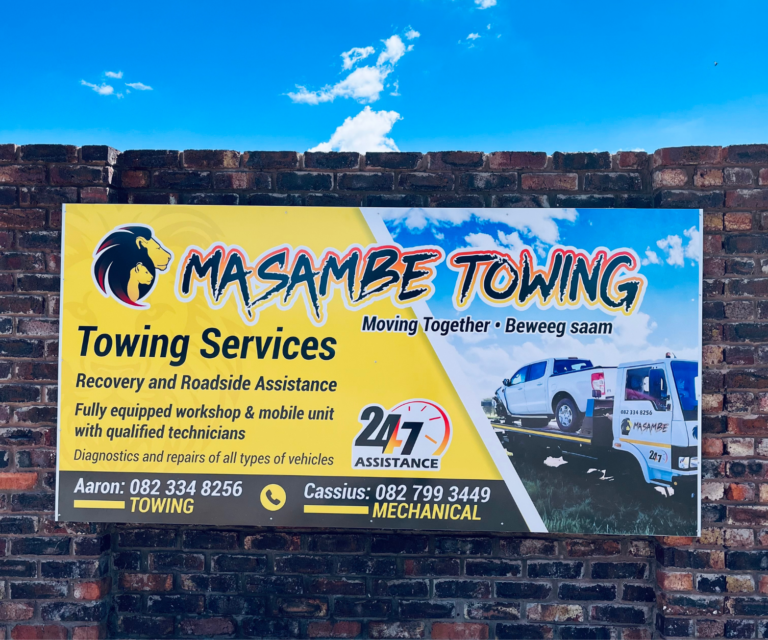 Signage board on a wall displaying the company details