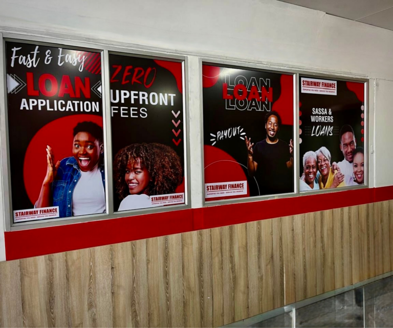 Red and black signage in the windows of a cashloan shop